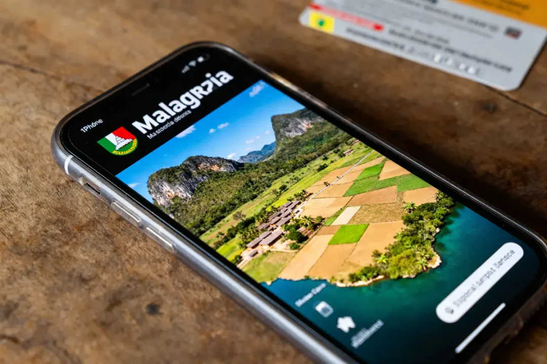 Téléphone affichant paysage rural illustrant la superficie de Madagascar avec des champs et collines